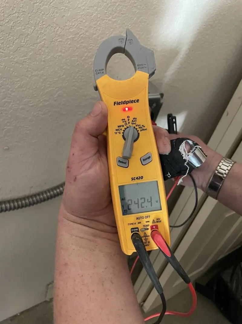 Voltage testing with clamp meter during Outlet Installation in Orland Hills